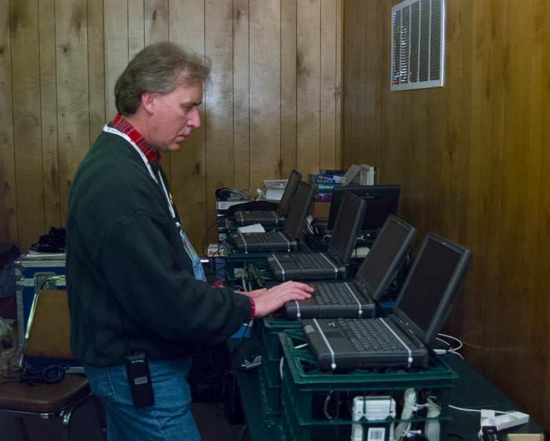 A man works at a vintage computer laptop