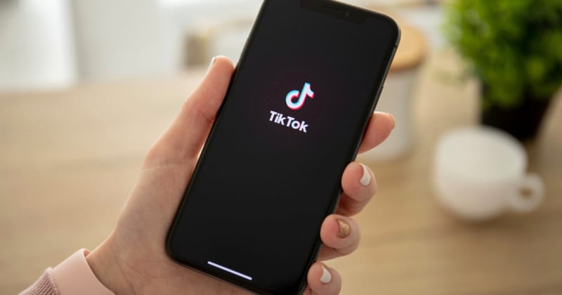 Person holds phone with TikTok on it