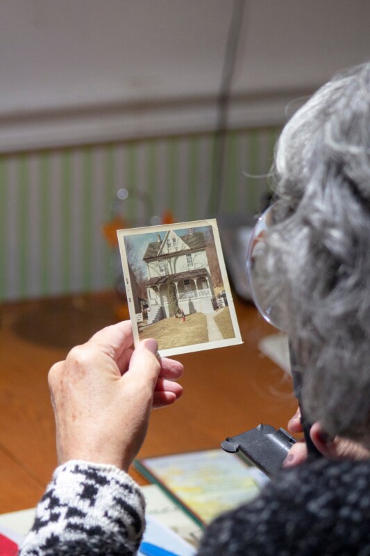 old woman holding a vintage photograph