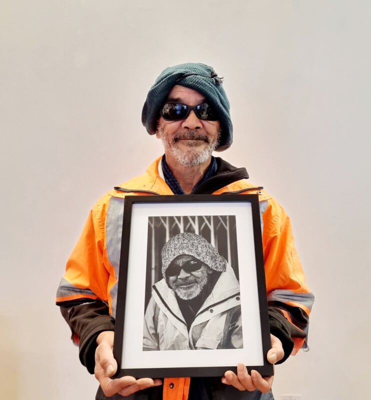 Allan holding his framed portrait.