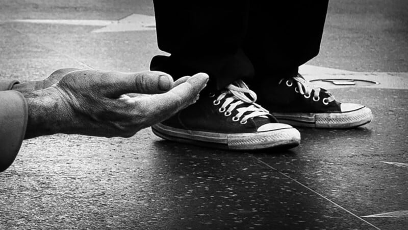 A homeless person begging in Hollywood