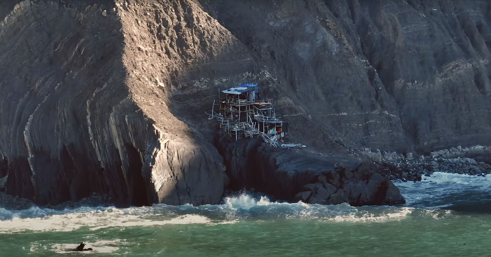 Drone Photographer Discovers Mystery Driftwood Shack Perched on Cliff