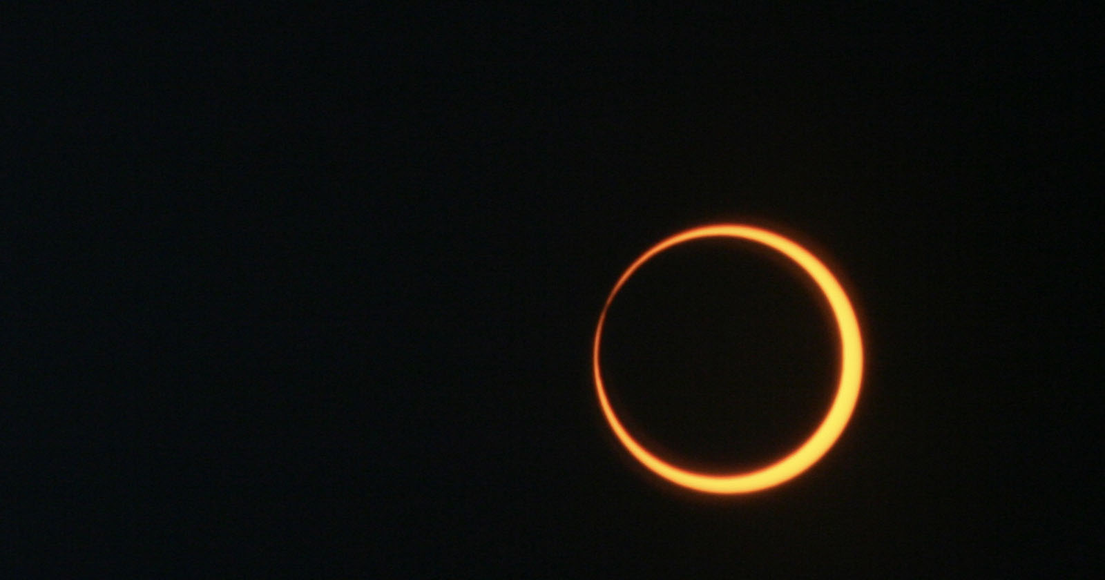 A partial eclipse against a black sky.