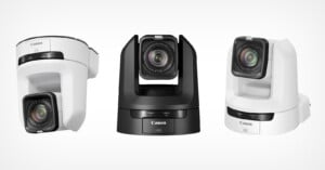 Three models of the Canon CR-N100 PTZ camera are lined up in a row, two white with one in black in the middle.