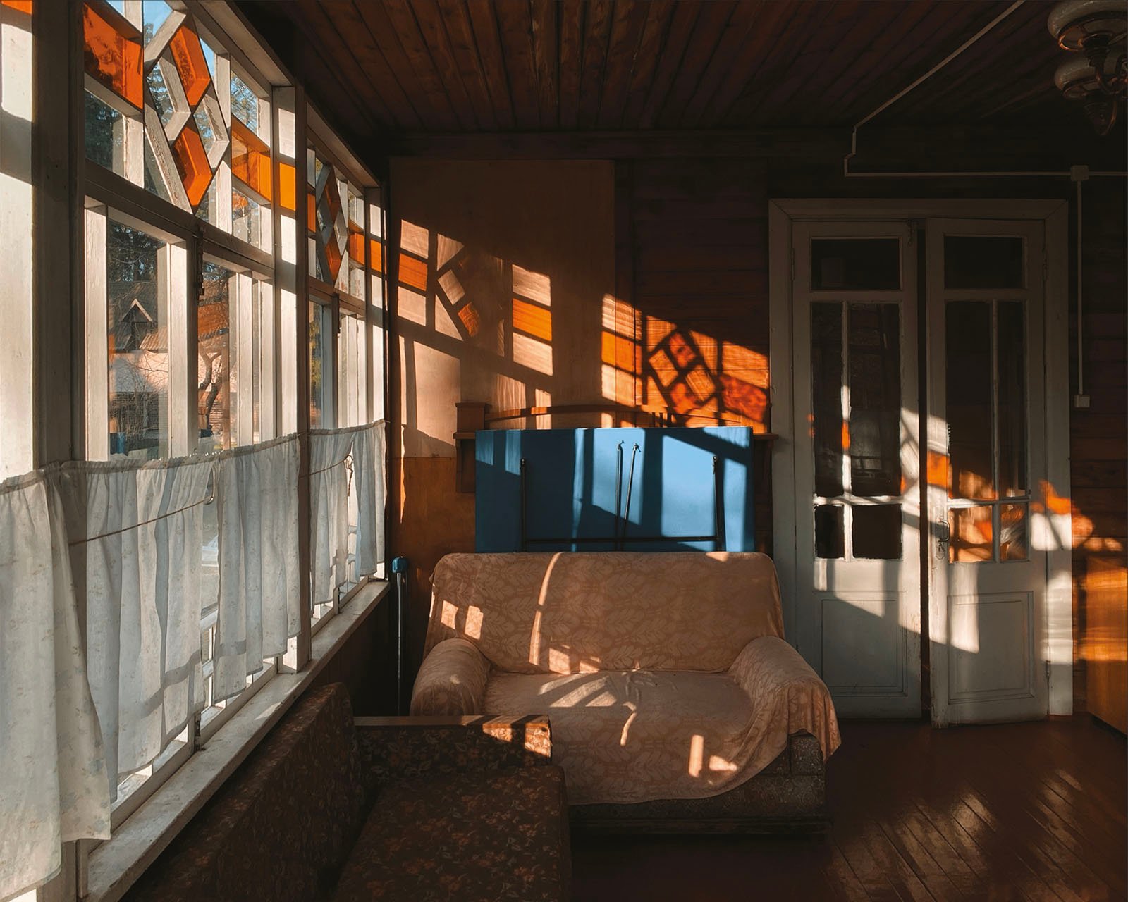 Light streams in from a window showing the inside of a dacha cottage.