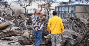 Two men look at the destruction after the Lahaina fires.