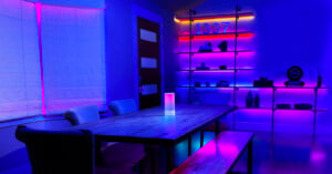 A dining room with purple lighting produces by Razer's new smart lighting products.