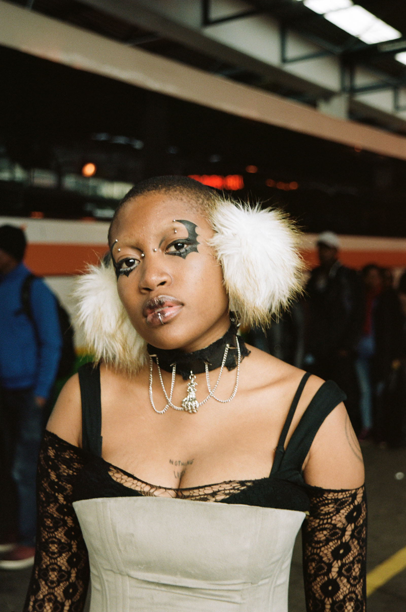 A portrait of a woman in earmuffs looking at the camera.