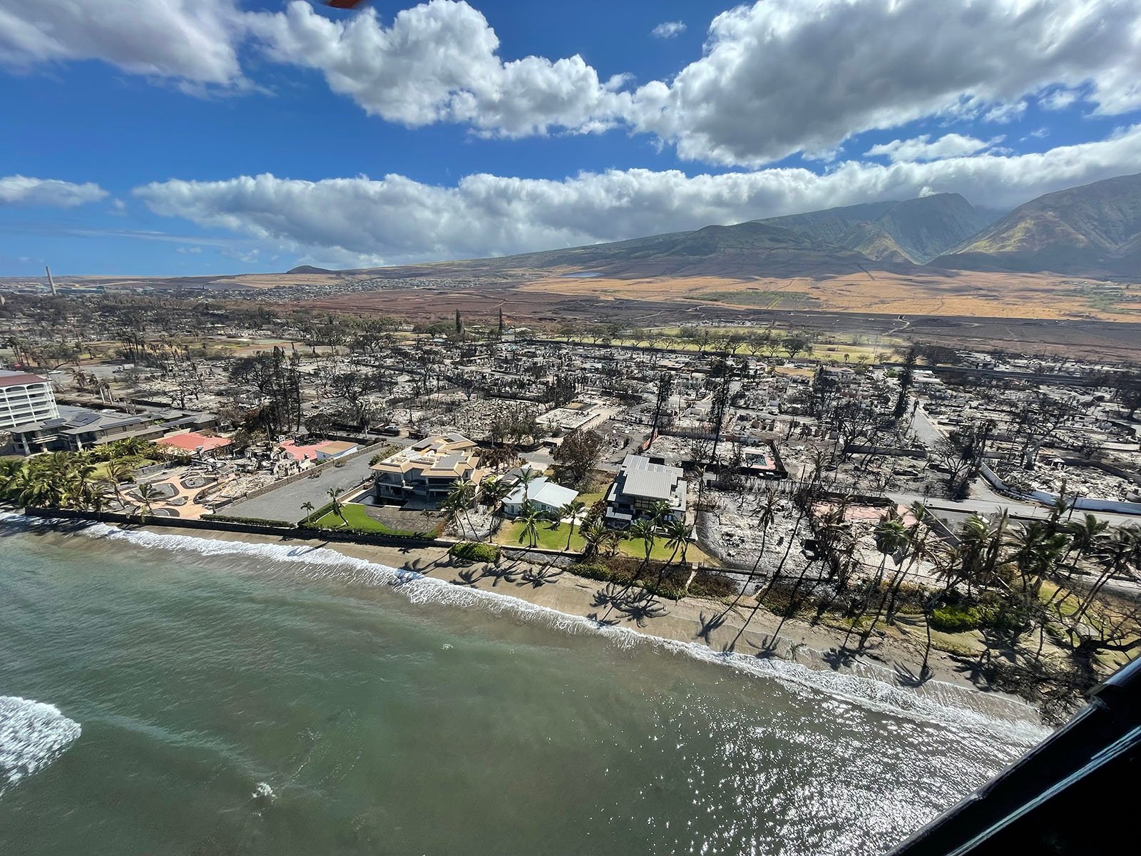 An aerial view of Hawaii after the fires by the water.