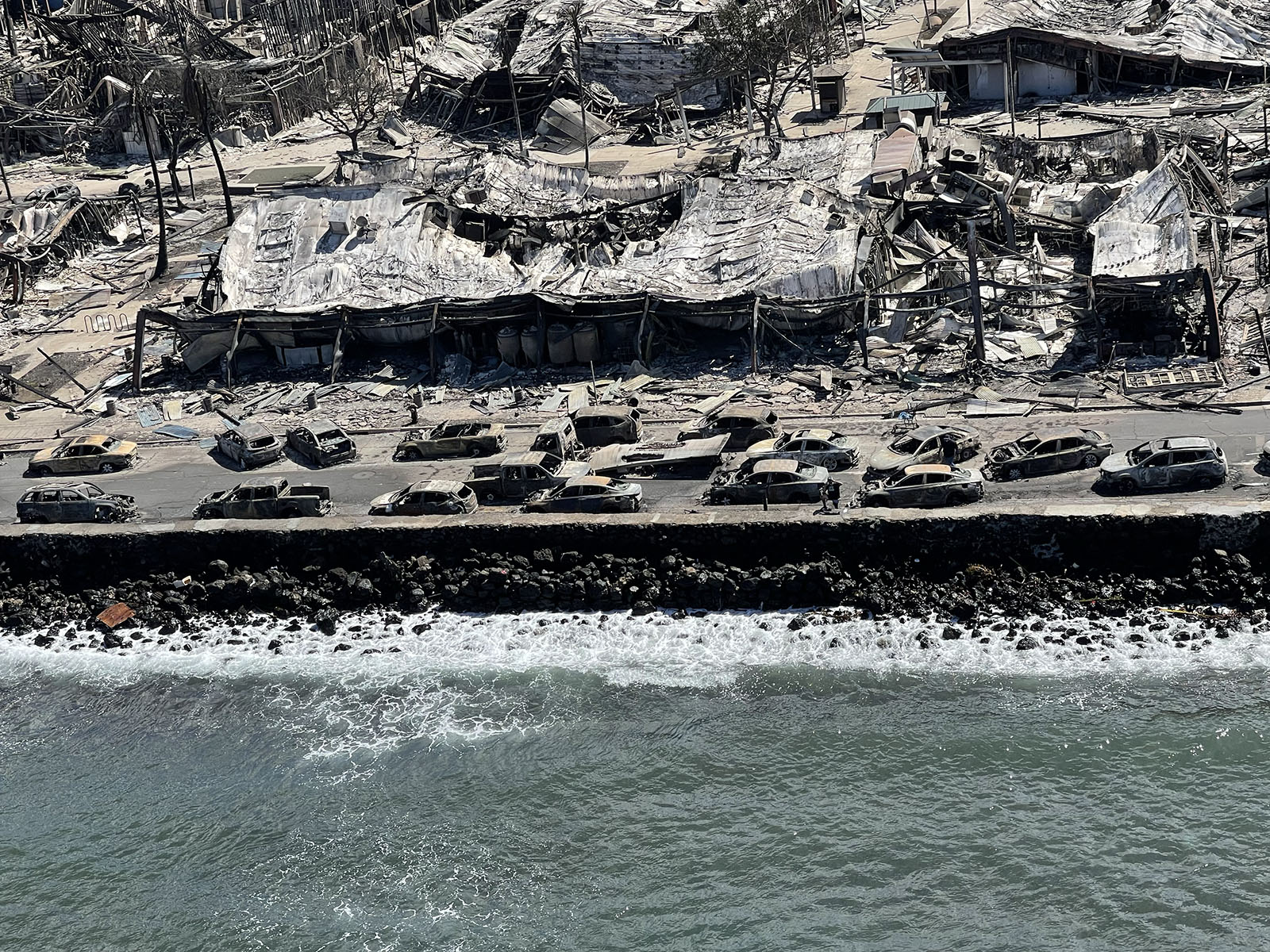 A street fulled of burnt cars seen from above.