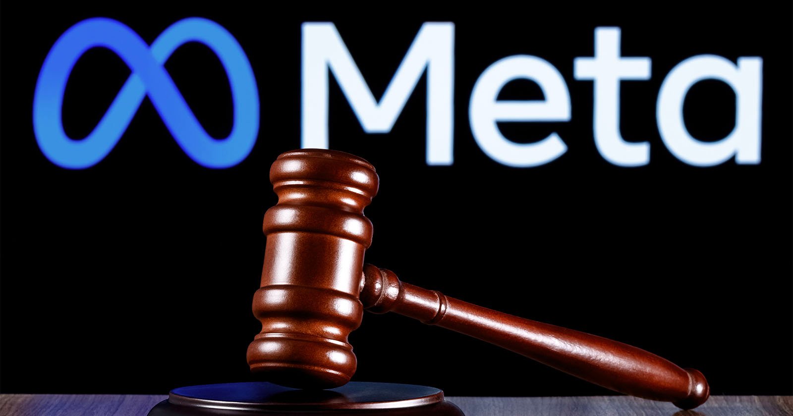 Meta's logo is seen behind a judge's gavel. 