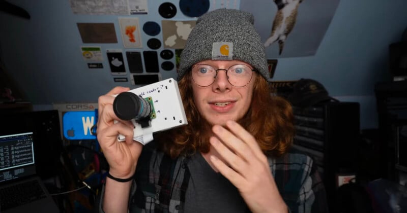 Creator Boaz holds up a 3D printed camera using Raspberry Pi.