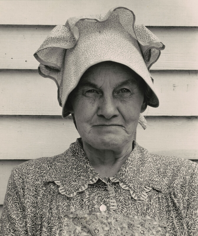 A woman in an old-fashioned sunbonnet.