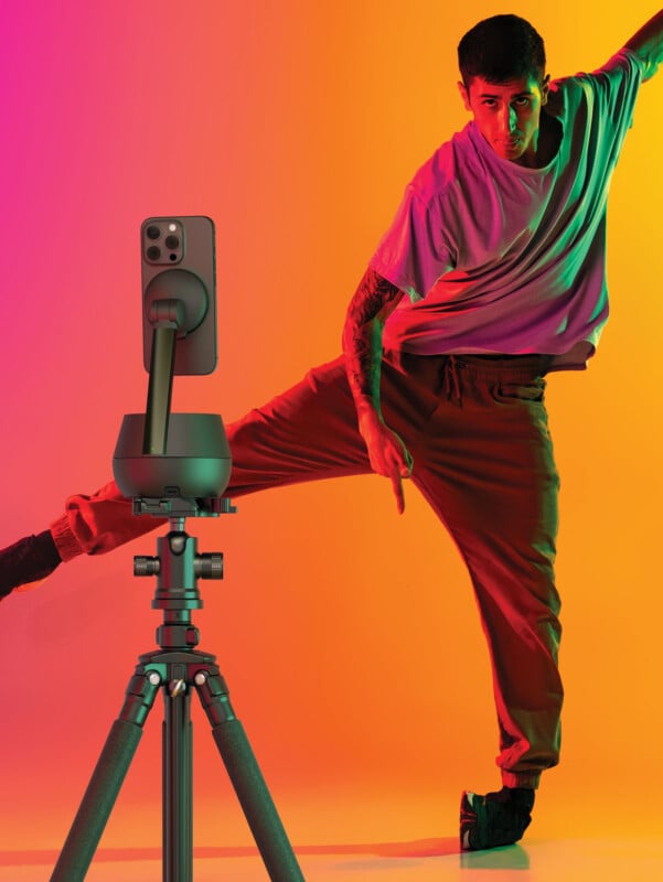 Portrait of young man, break dancing dancer training in casual clothes isolated over gradient pink yellow background at dance hall. Youth culture, movement, street style and fashion, action.