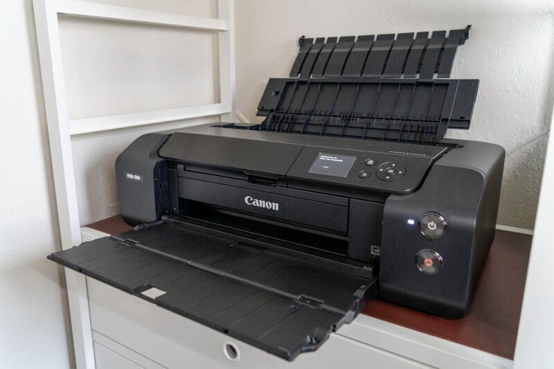 The Canon imagePROGRAF Pro-300 photo printer sits on a shelf. 