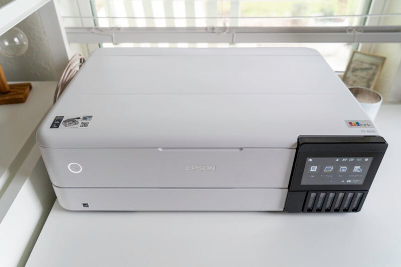 The EPson ET-8550 sits on a white desk in front of a window.