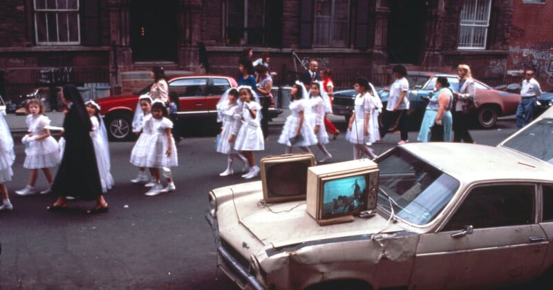 A parade of children participating communion walking on the street.