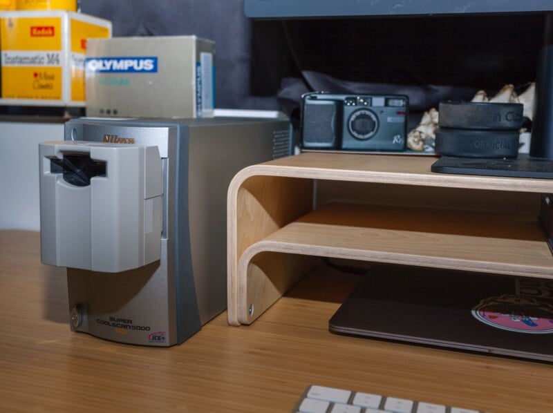 a nikon film scanner on a desk with a computer