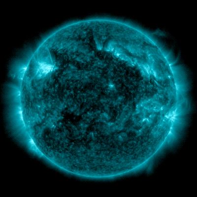 A GIF shows the Sun, shown in teal, as two solar flares erupt. 