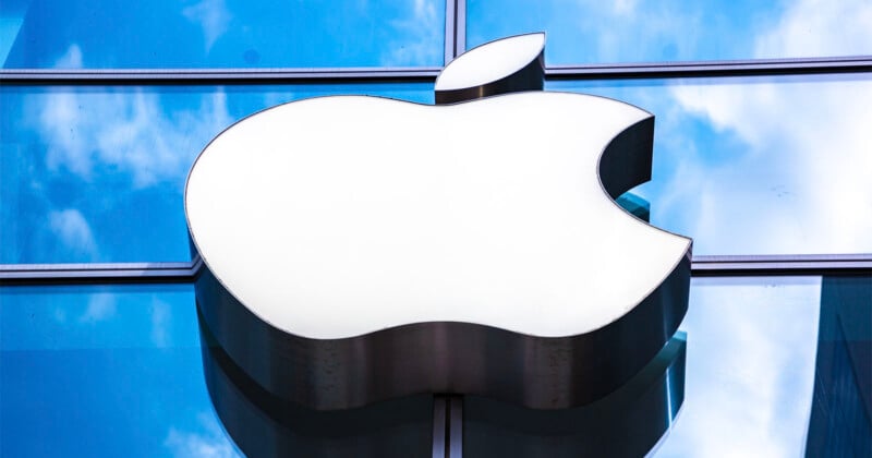 The Apple logo seen on a glass building facade.