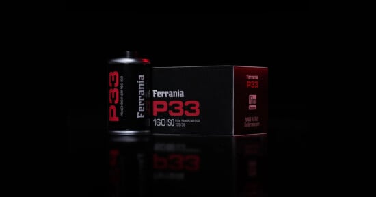 A roll of Ferrania P33 sits next to its box against a black background.