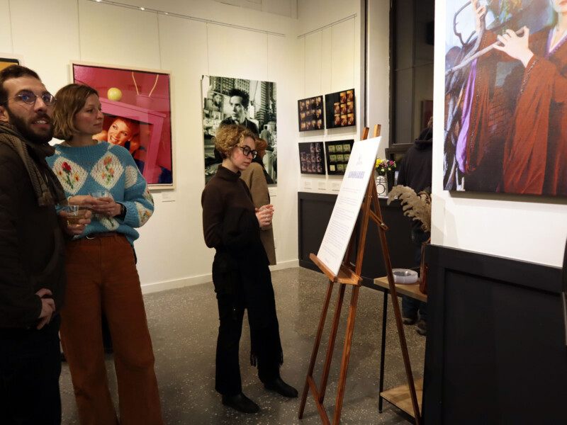 People observe the art at the Luminaries solo exhibition.