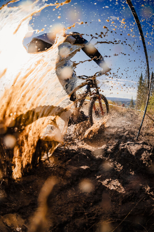 Sony World Photography Awards 2024 Open competition category winners -- motion, mountain biker going through mud, wide-angle