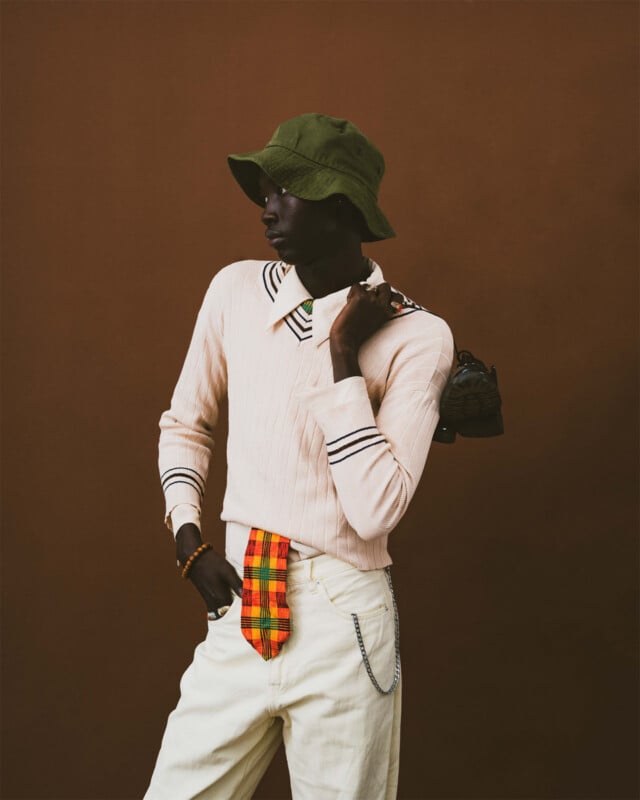 Sony World Photography Awards 2024 Open competition category winners -- lifestyle. Black man in a fashionable outfit against a dark brown background.