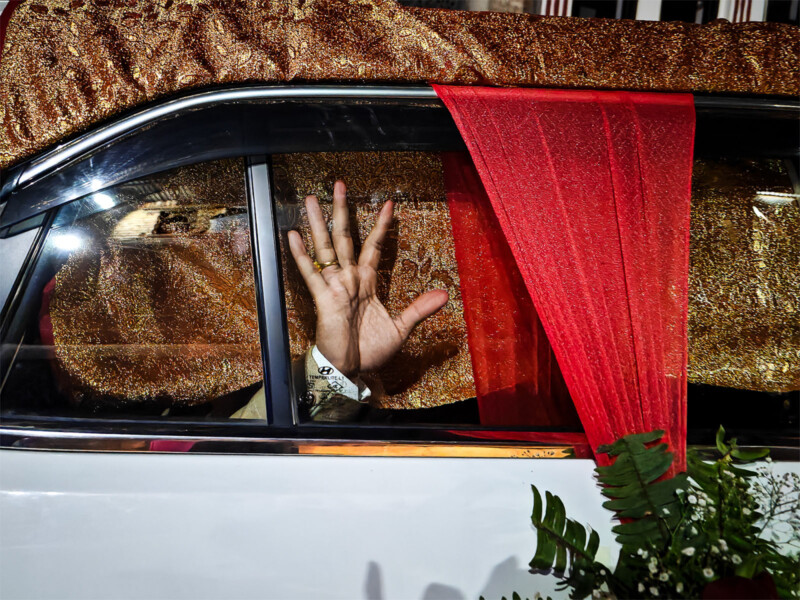 Sony World Photography Awards 2024 Open competition category winners -- street photography winner, a hand pressed againt a window of a passing car.