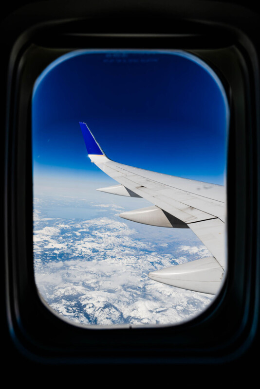 Graham Washatka aerial landscape photograph, blue sky, plane wing, window framing