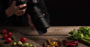 A person takes a photo of food.