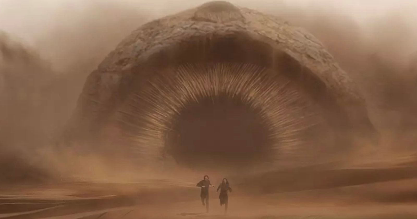 Paul Atreides (Timothee Chalamet) and his mother Lady Jessica (Rebecca Ferguson), run away from a huge sandworm in "Dune"