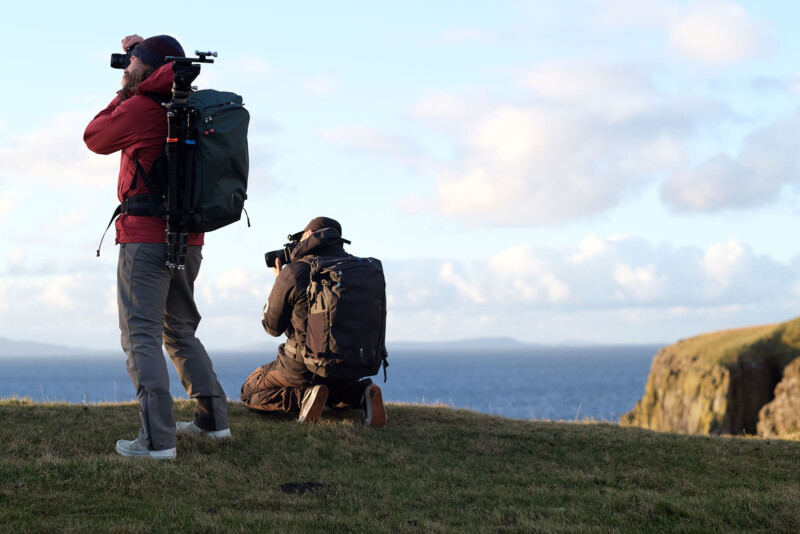 Two photographers take pictures outside with Fjord 50-C backpacks.