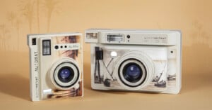 The Lomo'Instant Automat and Lomo'Instant Wide el Nil versions sit on a tan background with an Egyptian scene faded in the background.