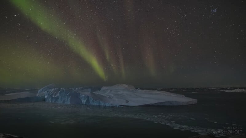 The northern lights are seen over icebergs.