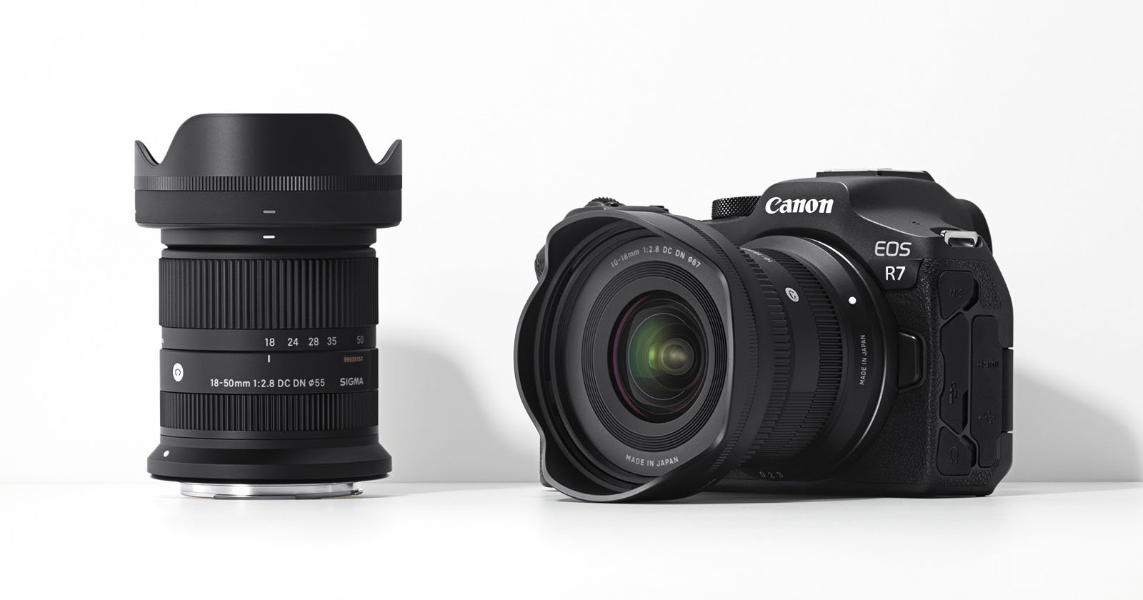 A canon eos r7 camera accompanied by two lenses—the ef-m 18-150mm and sigma 56mm—displayed against a plain white background.