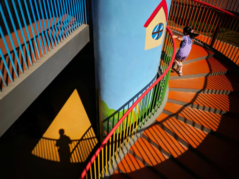 A child walks up colorful steps.