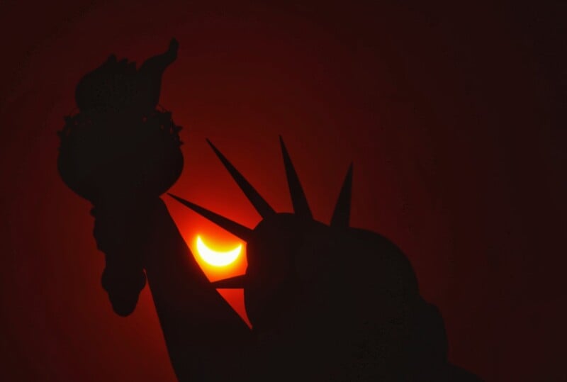 Partial solar eclipse and the Statue of Liberty