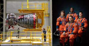 Five astronauts in orange suits standing confidently next to a spacecraft engine in a technical facility with industrial equipment and scaffolding.