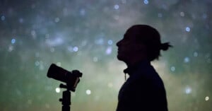 Alyn Wallace, award-winning astrophotographer, against a night sky