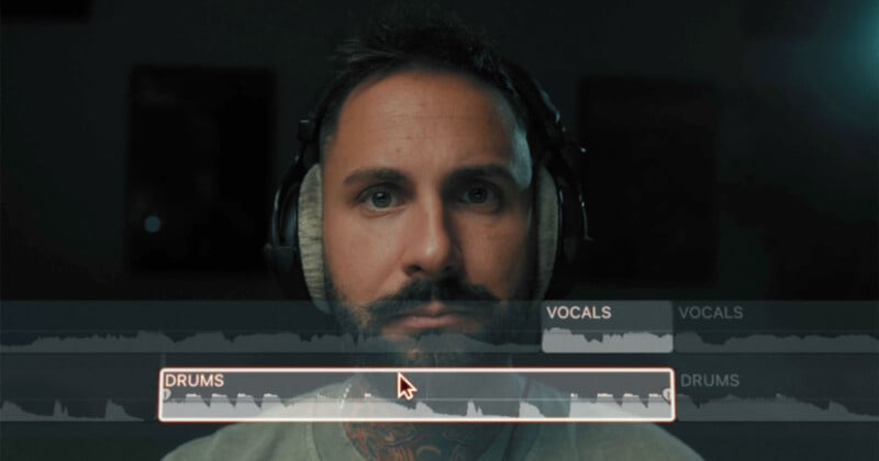 A man with a beard wearing headphones looks intently at a computer screen displaying audio tracks labeled "vocals" and "drums.
