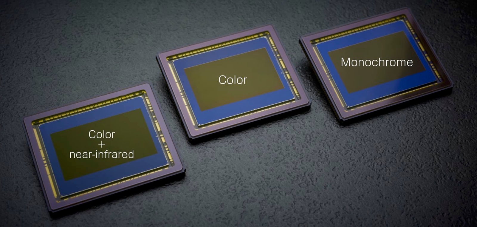 Three types of digital image sensors labeled "color + near-infrared," "color," and "monochrome," displayed on a dark textured surface.
