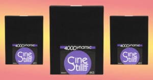 Three boxes of CineStill 400D 4x5 film are placed against a yellow to pink gradient.