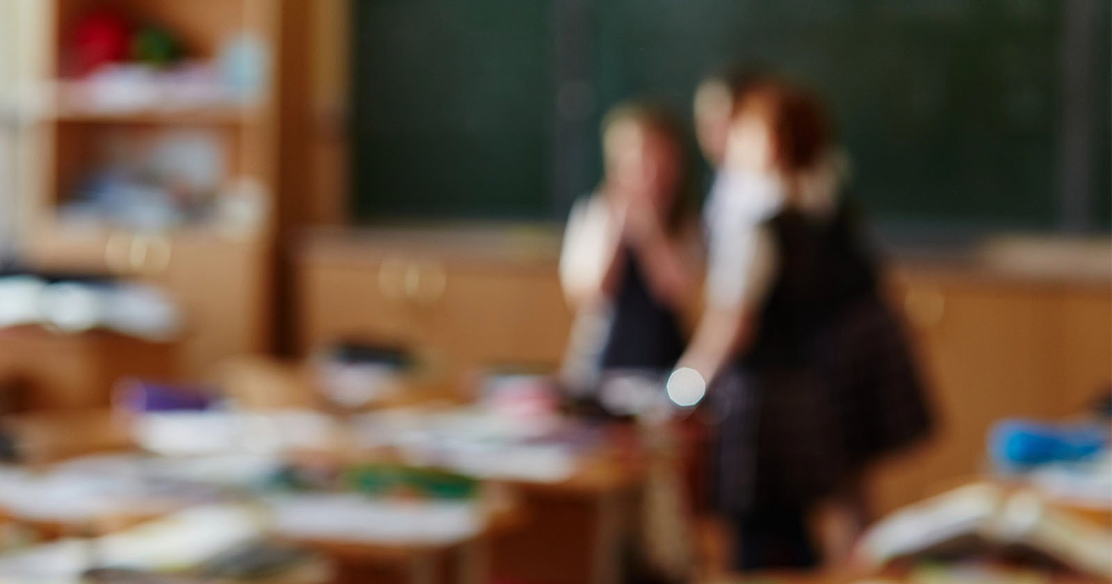 A blurred photo of students in a classroom.