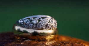 Wedding rings are stacked on top of each other on a rock.