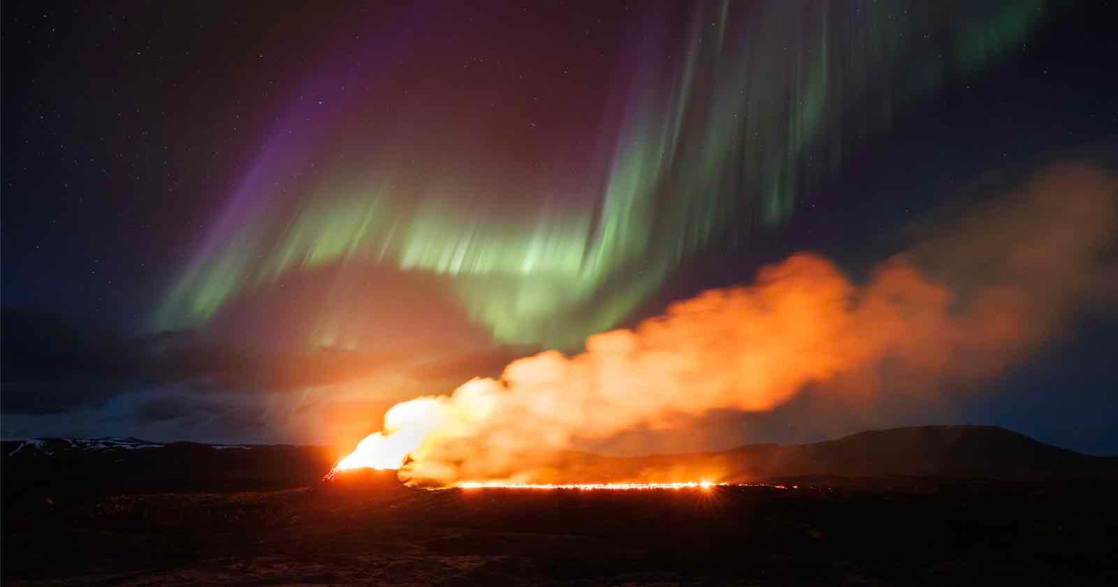 header image northern lights over active volcano