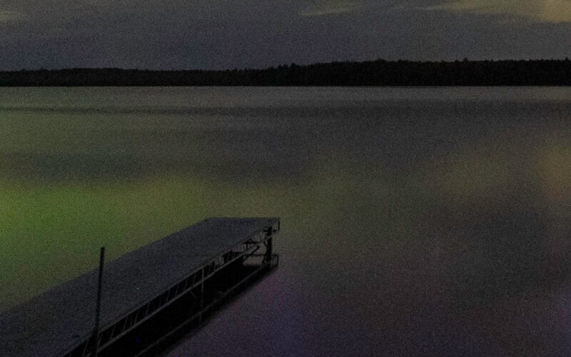 A dock in the water at night. 
