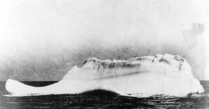 Black and white historical photograph showing iceberg sunk Titanic.