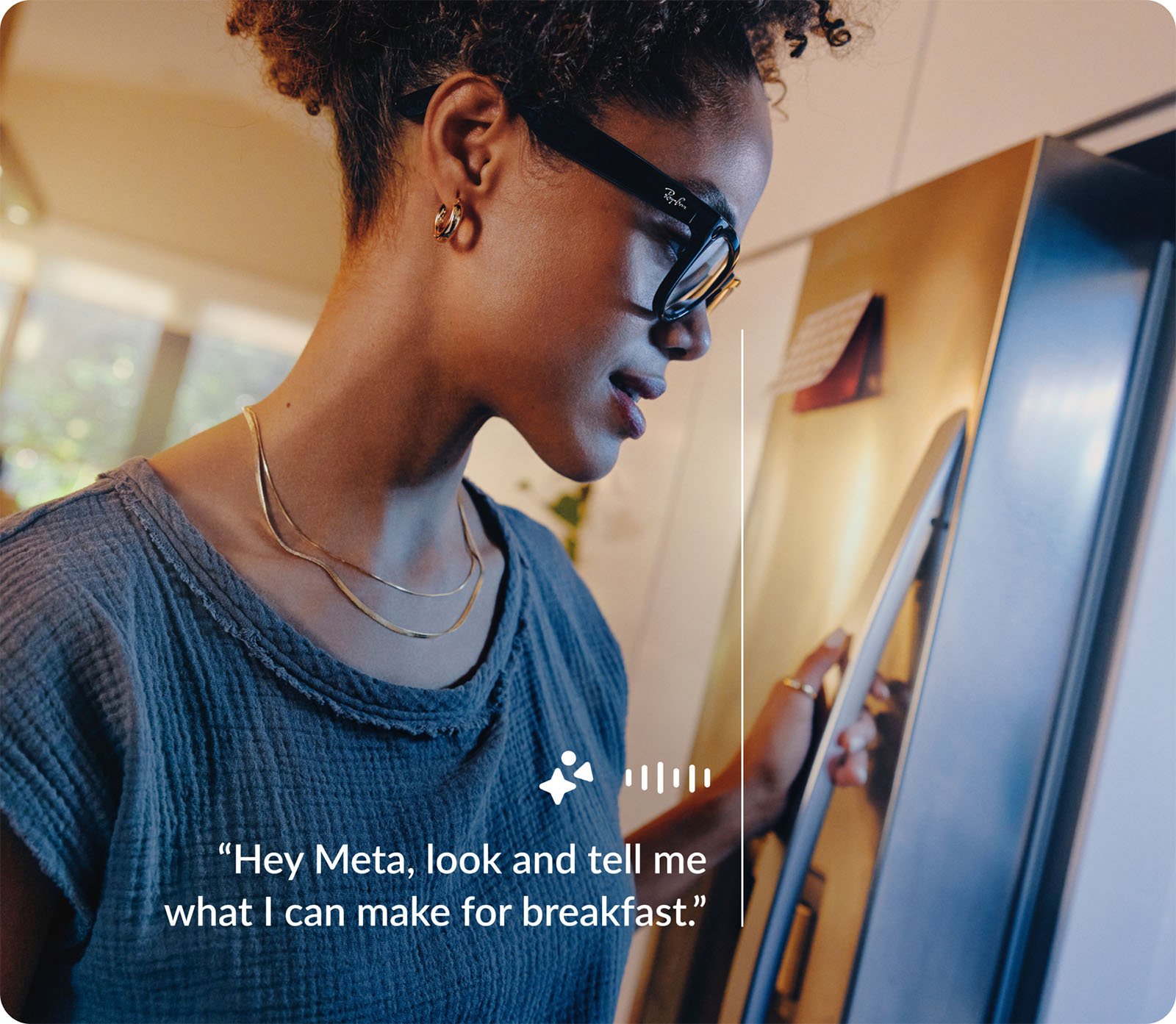 A woman wearing smart glasses speaks to her device while looking inside a refrigerator in a sunny kitchen, asking for breakfast suggestions.