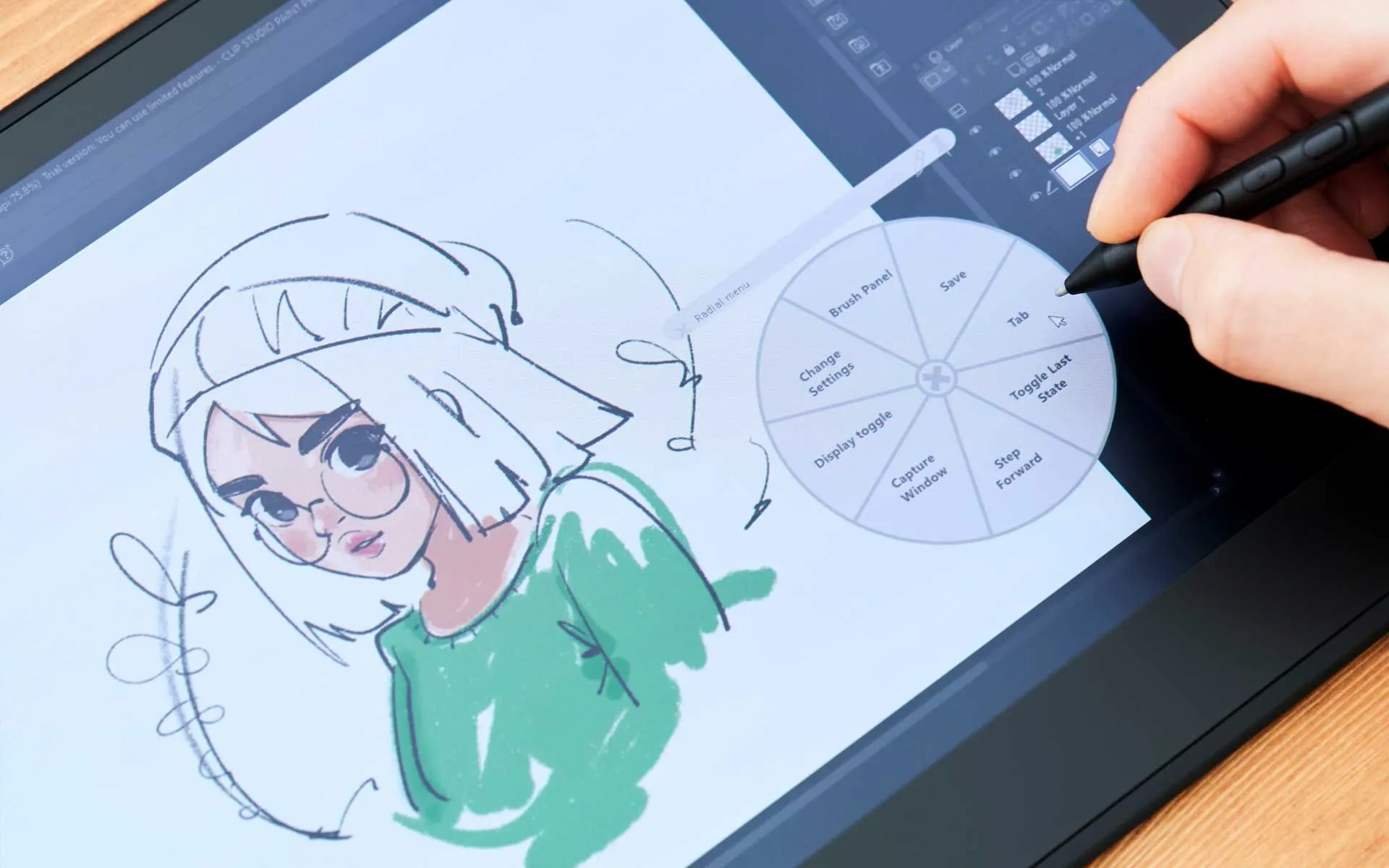 A hand using a stylus to draw a female cartoon character with glasses on a digital drawing tablet, which also displays a color wheel tool.